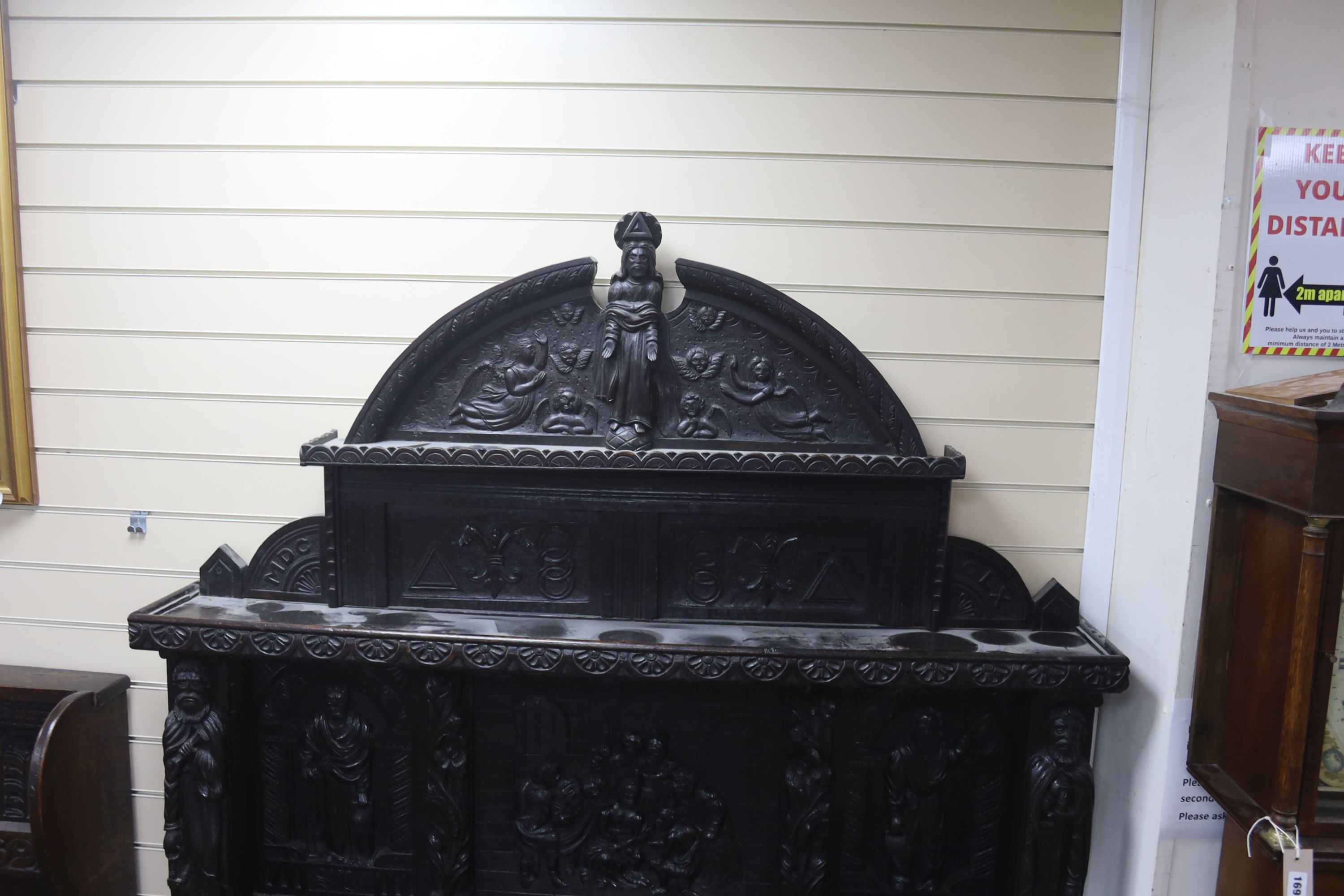 A late 19th century Flemish carved oak sideboard with raised panelled back, width 150, depth 60, height 215 cms.